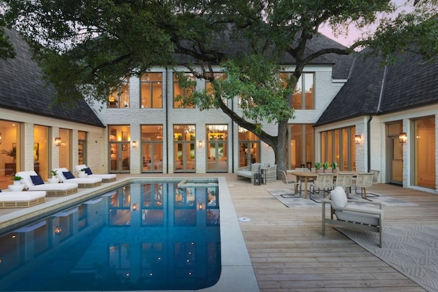 3614 Murillo Cir, Austin, TX 78703 - rear view of house with a deck, an outdoor pool, a shingled roof, and outdoor dining space