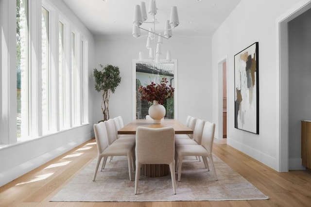 3614 Murillo Cir, Austin, TX 78703 - dining area with a chandelier, light wood-type flooring, and baseboards
