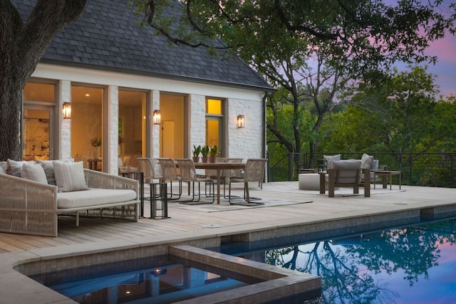 3614 Murillo Cir, Austin, TX 78703 - pool at dusk featuring an outdoor pool, an outdoor structure, an outdoor hangout area, a storage structure, and a wooden deck