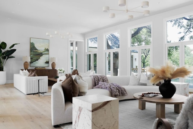 3614 Murillo Cir, Austin, TX 78703 - living room with a chandelier, healthy amount of natural light, and light wood-type flooring