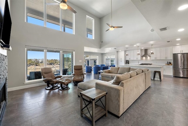 living room featuring a fireplace, recessed lighting, visible vents, a ceiling fan, and baseboards