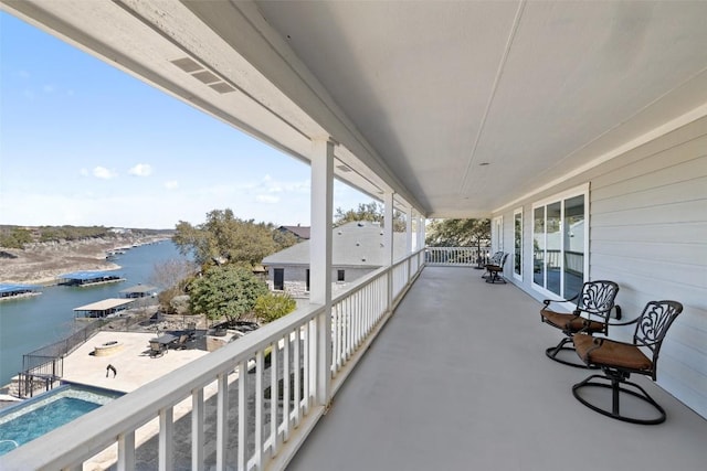 balcony with a water view and a sunroom