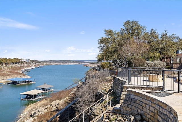 property view of water featuring fence