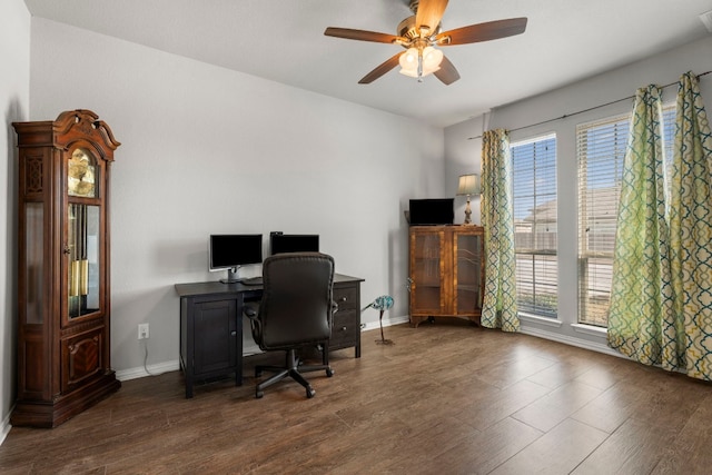 home office featuring ceiling fan, baseboards, a healthy amount of sunlight, and wood finished floors