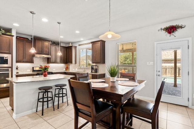 dining space with light tile patterned flooring and recessed lighting