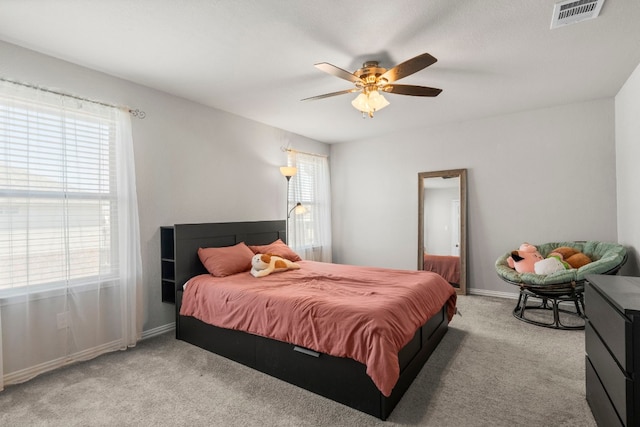bedroom with ceiling fan, carpet floors, baseboards, and visible vents