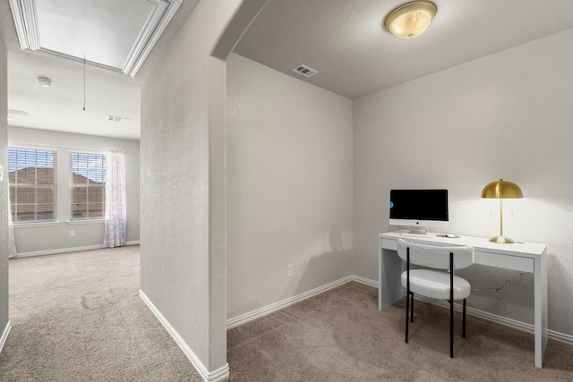 carpeted office space featuring attic access, visible vents, baseboards, and arched walkways