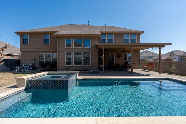 view of pool with a patio area, a pool with connected hot tub, and a fenced backyard