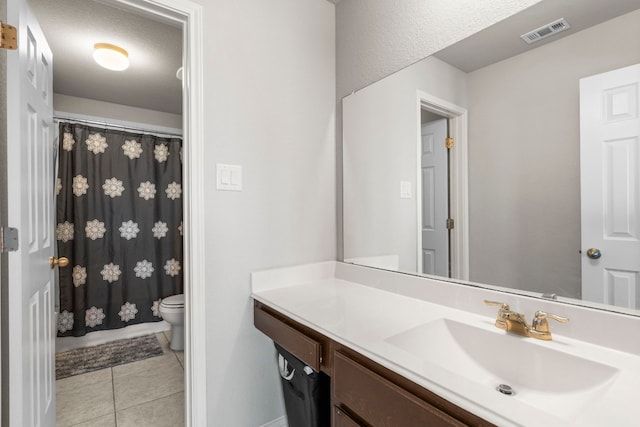 bathroom with toilet, visible vents, curtained shower, tile patterned floors, and vanity