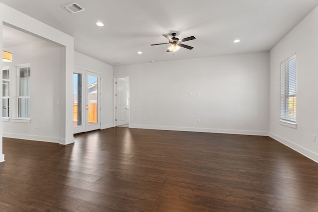 empty room featuring recessed lighting, dark wood-style flooring, visible vents, and baseboards