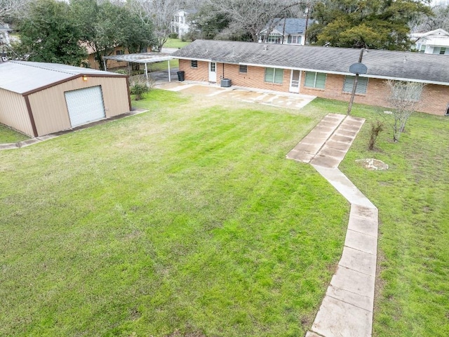 view of yard featuring central AC, an outdoor structure, and a detached garage