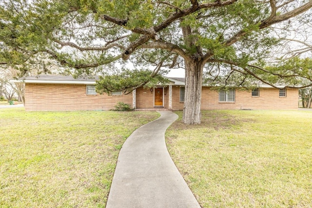 ranch-style home with brick siding and a front yard