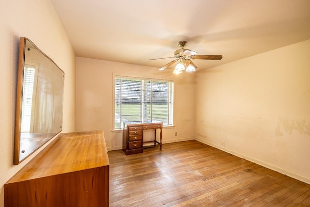 interior space with wood-type flooring, baseboards, and ceiling fan