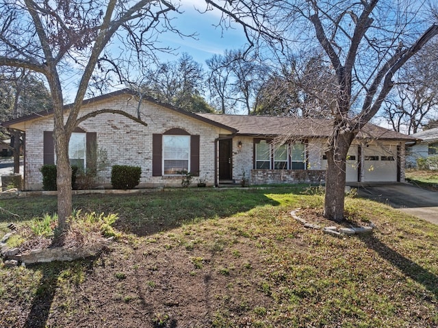 ranch-style home with an attached garage, a front lawn, concrete driveway, and brick siding