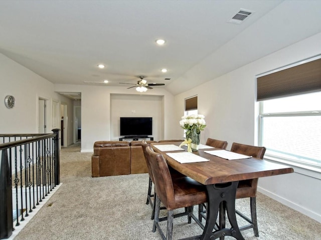 dining area with lofted ceiling, recessed lighting, light colored carpet, visible vents, and baseboards