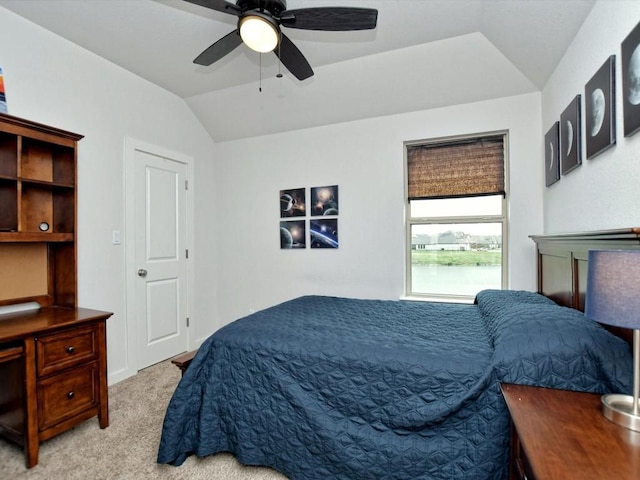 bedroom with vaulted ceiling, ceiling fan, and light carpet