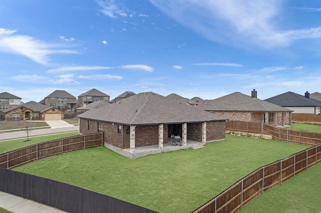 view of yard featuring a residential view, a fenced backyard, and a patio