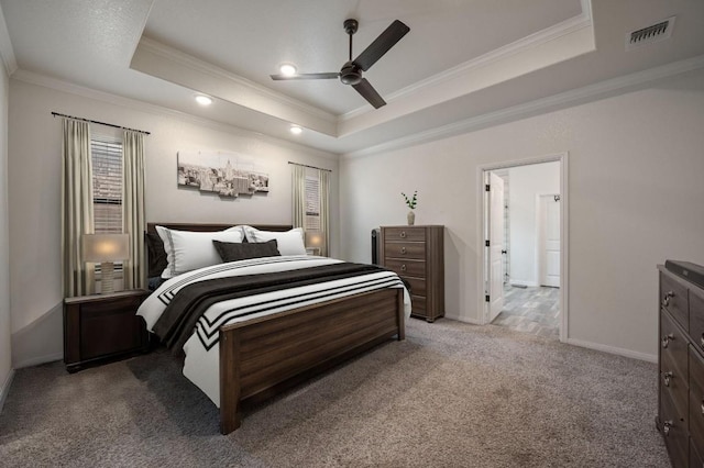 bedroom featuring ornamental molding, a tray ceiling, carpet, and visible vents