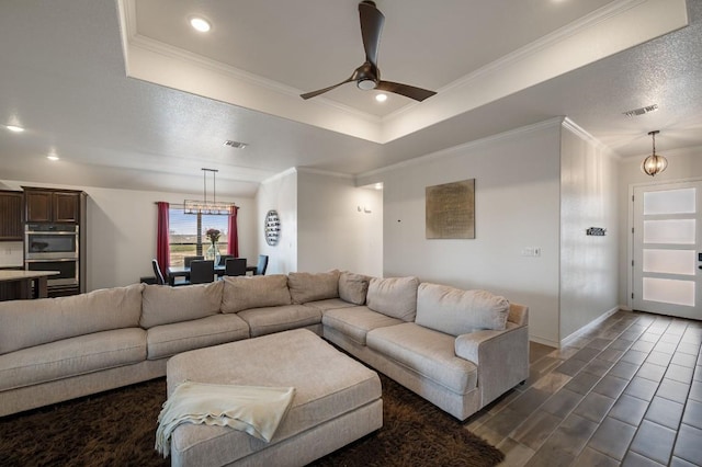 living area featuring recessed lighting, a ceiling fan, visible vents, a tray ceiling, and crown molding