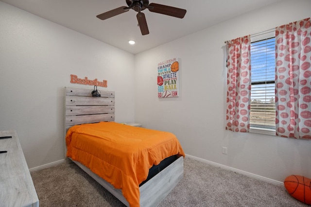 carpeted bedroom with baseboards and a ceiling fan