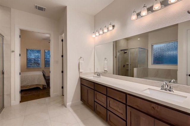 219 Baldovino Skwy, Lakeway, TX 78738 - ensuite bathroom featuring a stall shower, a garden tub, double vanity, and tile patterned flooring