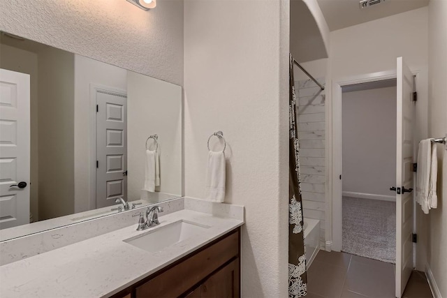 219 Baldovino Skwy, Lakeway, TX 78738 - full bath featuring vanity, tile patterned floors, and shower / bath combination with curtain