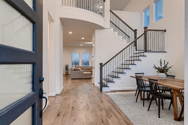 219 Baldovino Skwy, Lakeway, TX 78738 - foyer entrance featuring a towering ceiling, stairs, wood finished floors, and recessed lighting