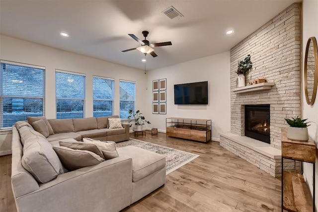 219 Baldovino Skwy, Lakeway, TX 78738 - living room with a ceiling fan, wood finished floors, a fireplace, and recessed lighting