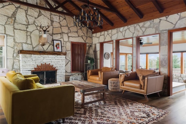 19745 Lakehurst Loop, Spicewood, TX 78669 - living area with wooden ceiling with exposed beams, high vaulted ceiling, wood finished floors, a chandelier, and a stone fireplace
