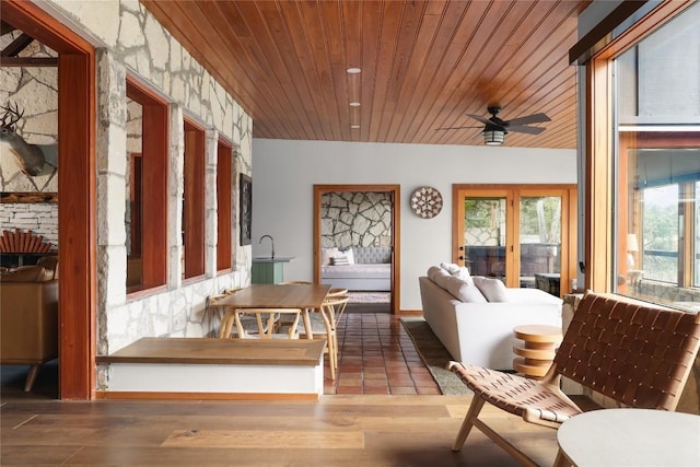 19745 Lakehurst Loop, Spicewood, TX 78669 - living room with healthy amount of natural light, ceiling fan, wooden ceiling, and wood finished floors