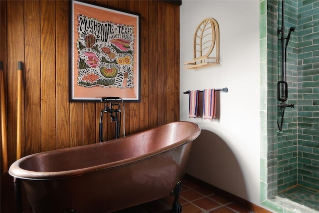 19745 Lakehurst Loop, Spicewood, TX 78669 - full bath featuring a freestanding tub, wooden walls, tile patterned flooring, and a tile shower