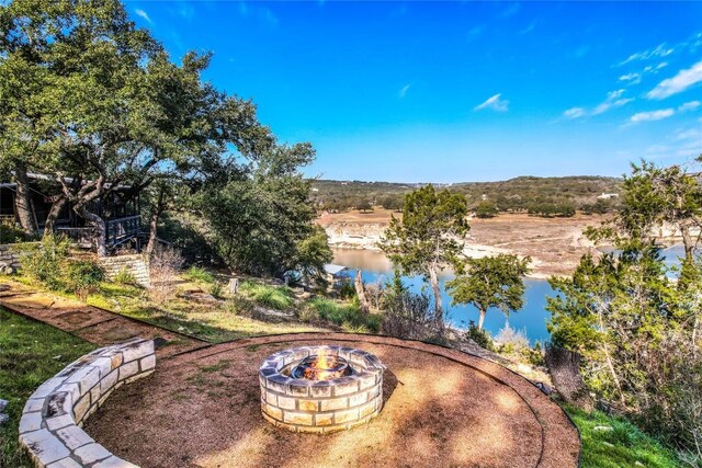 19745 Lakehurst Loop, Spicewood, TX 78669 - view of patio / terrace featuring an outdoor fire pit and a water view