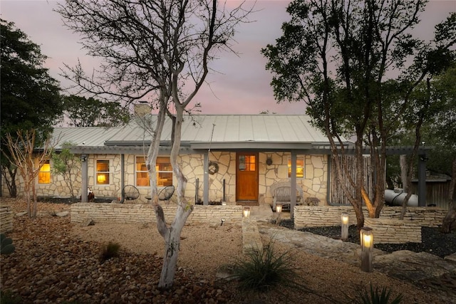 19745 Lakehurst Loop, Spicewood, TX 78669 - view of front of property featuring stone siding, a chimney, covered porch, metal roof, and a standing seam roof