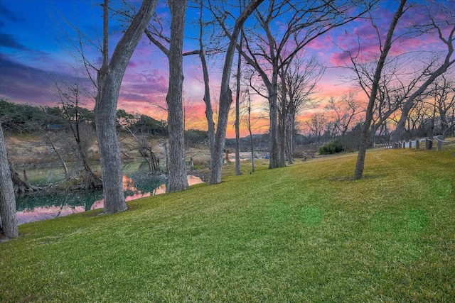 1920 River Rd, Wimberley, TX 78676 - yard at dusk featuring a lawn