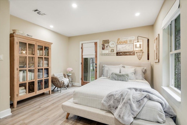 1920 River Rd, Wimberley, TX 78676 - bedroom with multiple windows, light wood finished floors, recessed lighting, and baseboards