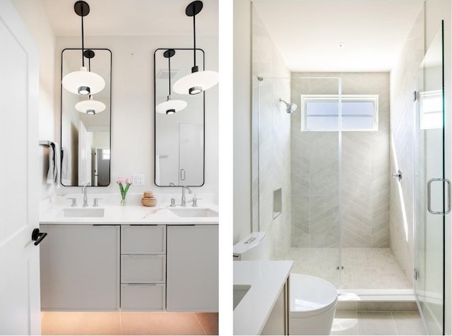 bathroom featuring double vanity, toilet, tile patterned flooring, a shower stall, and a sink