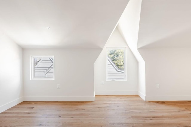 additional living space featuring light wood-style floors and baseboards