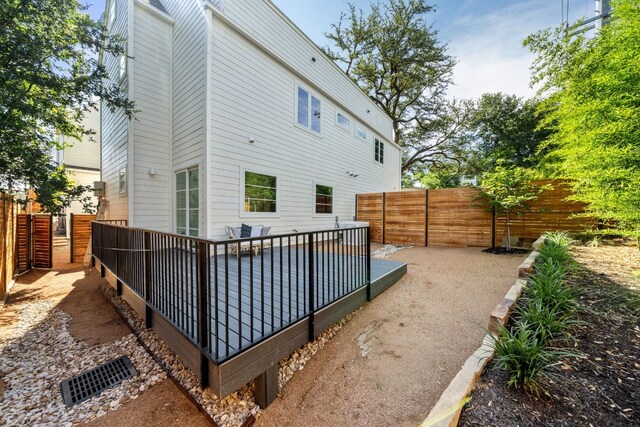 back of house with a fenced backyard