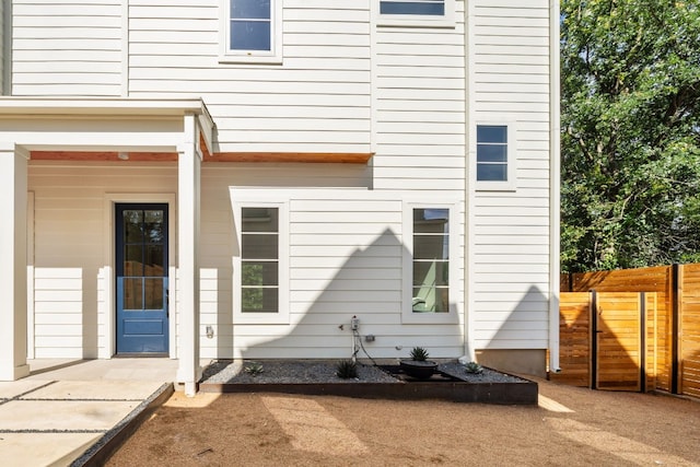 rear view of house featuring a patio and fence