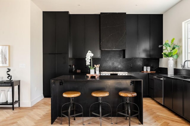 kitchen with dark countertops, a kitchen island, and dark cabinets