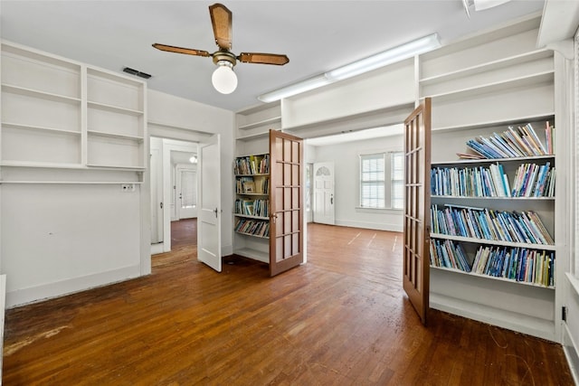 interior space featuring dark wood-style floors, french doors, visible vents, and a ceiling fan