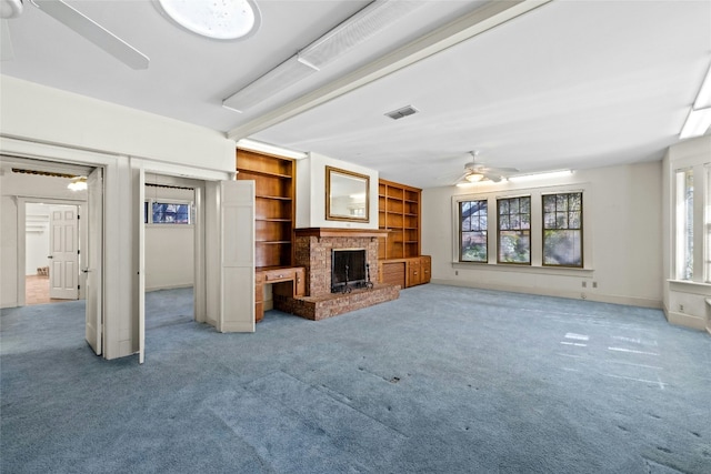 unfurnished living room with a brick fireplace, ceiling fan, visible vents, and light colored carpet