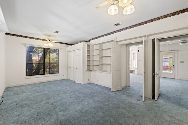 interior space featuring baseboards, visible vents, and a ceiling fan