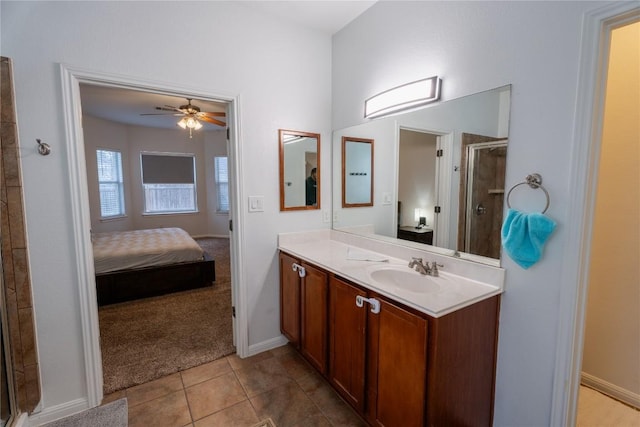 bathroom with ceiling fan, vanity, tile patterned floors, a stall shower, and ensuite bath