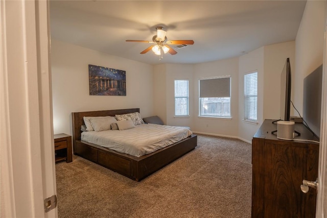 carpeted bedroom featuring baseboards and a ceiling fan