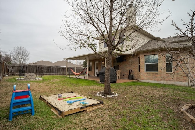 view of yard with a fire pit, a patio area, a fenced backyard, and central air condition unit