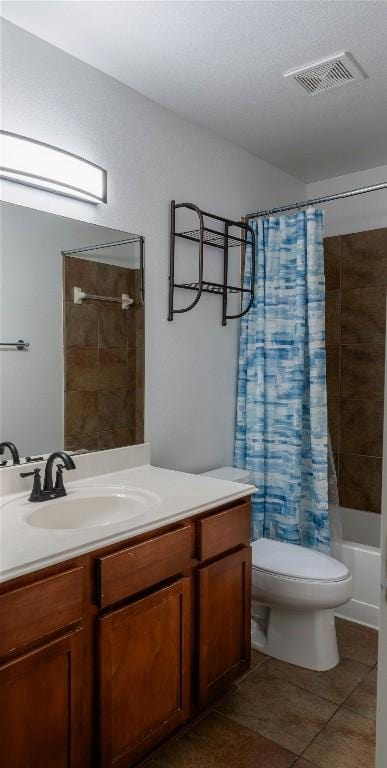 full bath with tile patterned flooring, toilet, vanity, visible vents, and shower / bath combination with curtain