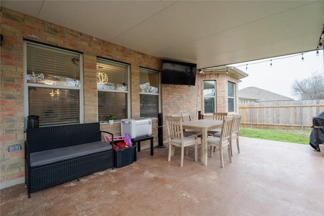 view of patio featuring fence and outdoor dining space