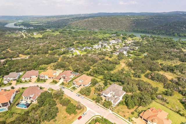 bird's eye view with a water view, a residential view, and a wooded view