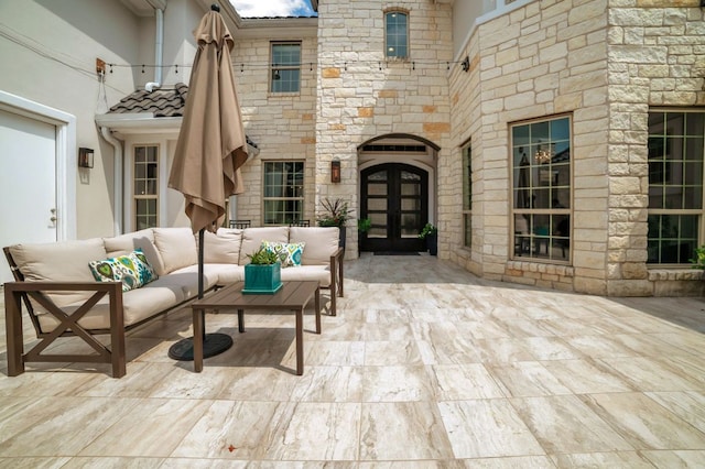 entrance to property with a patio area and an outdoor living space